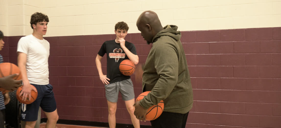 Baseline Hoops coach working with two players at a private training session