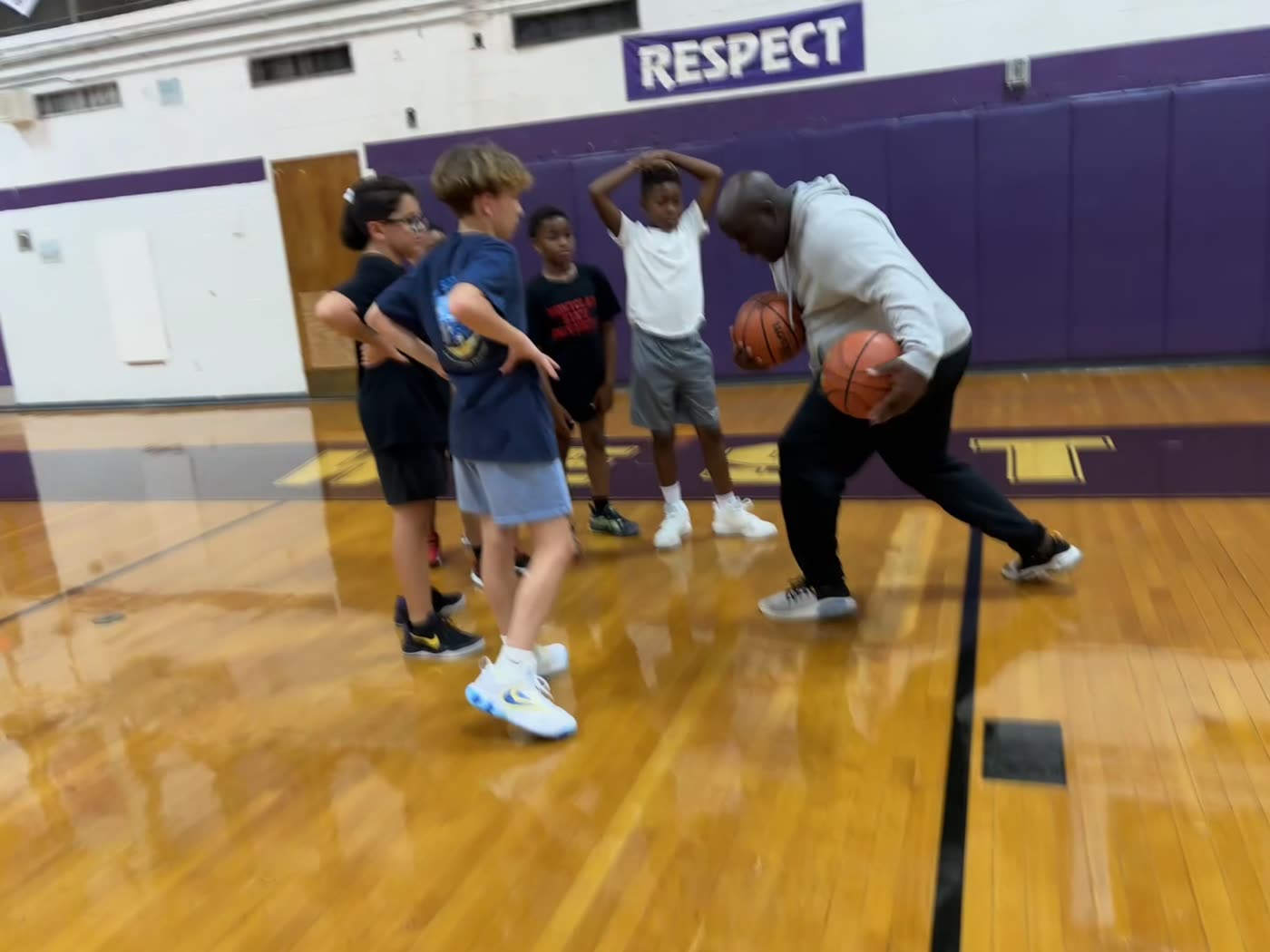 Coach leading a ball-handling drill with youth players at Baseline Hoops NJ